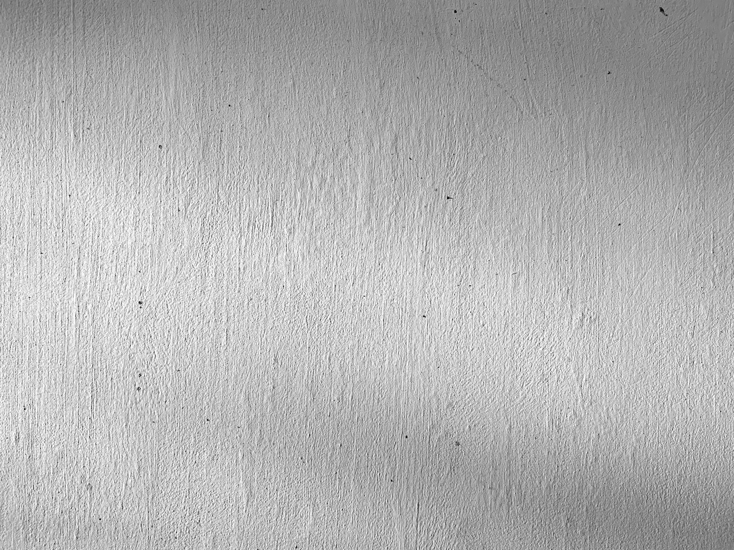 Textured white wall showing visible vertical paint brushstrokes.